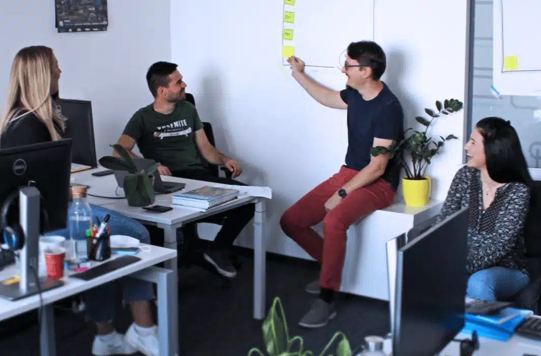 Image showing a team discussing something in front of a workspace