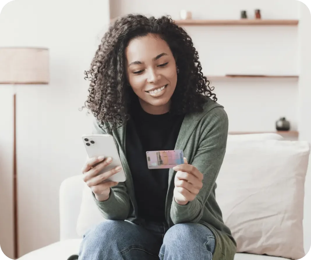 Satisfied user looking at a document and a phone.