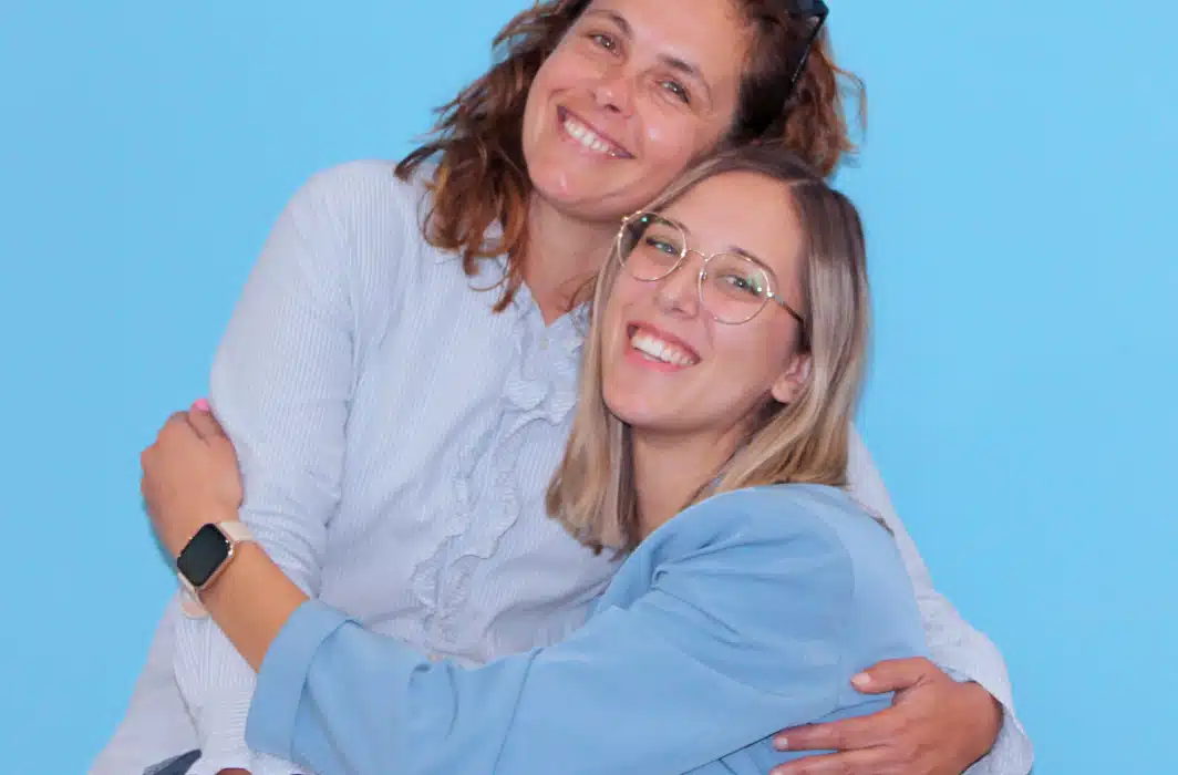 Image showing two women hugging and smiling happily in the Microblink office
