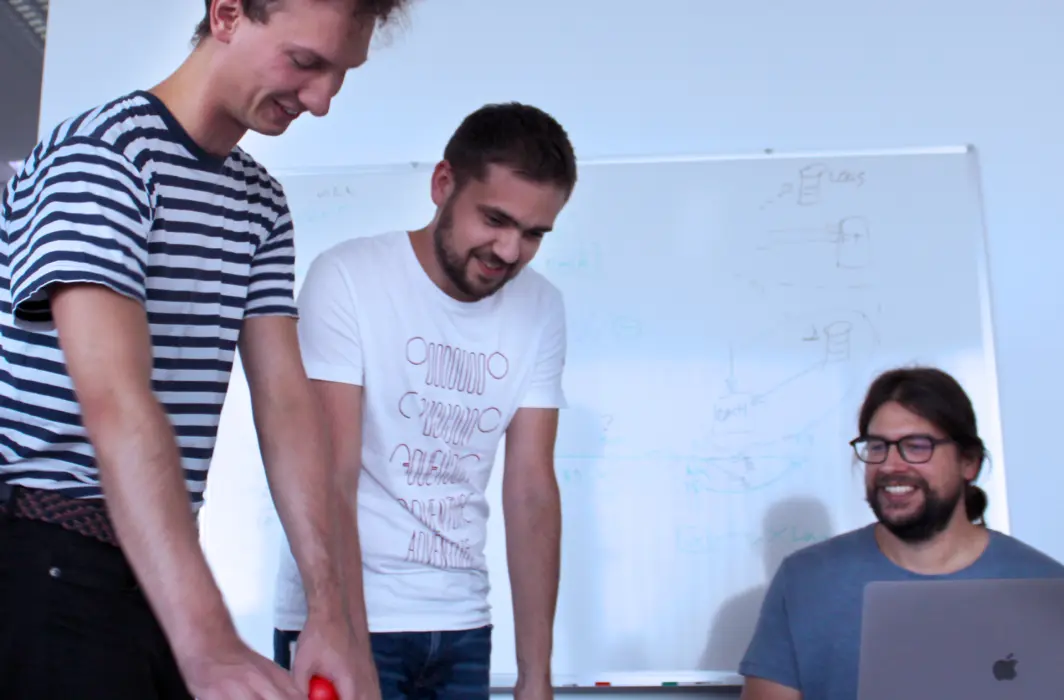 Image showing a team developing a product in front of their workstations